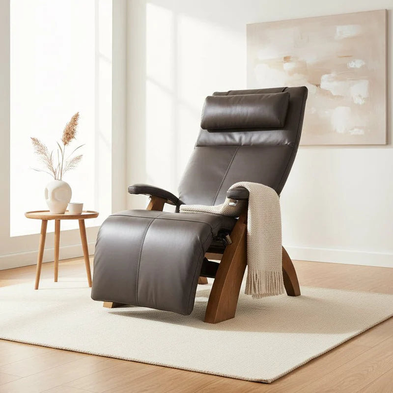 Espresso recliner chair in a modern living room with a side table and artwork.