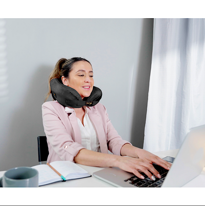 A woman wearing the Neck Sofa® Travel Neck Pillow.