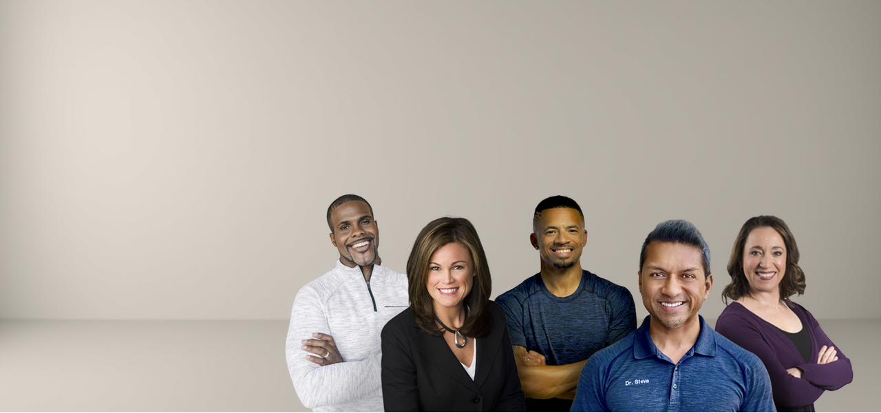 Five people standing together against a plain background