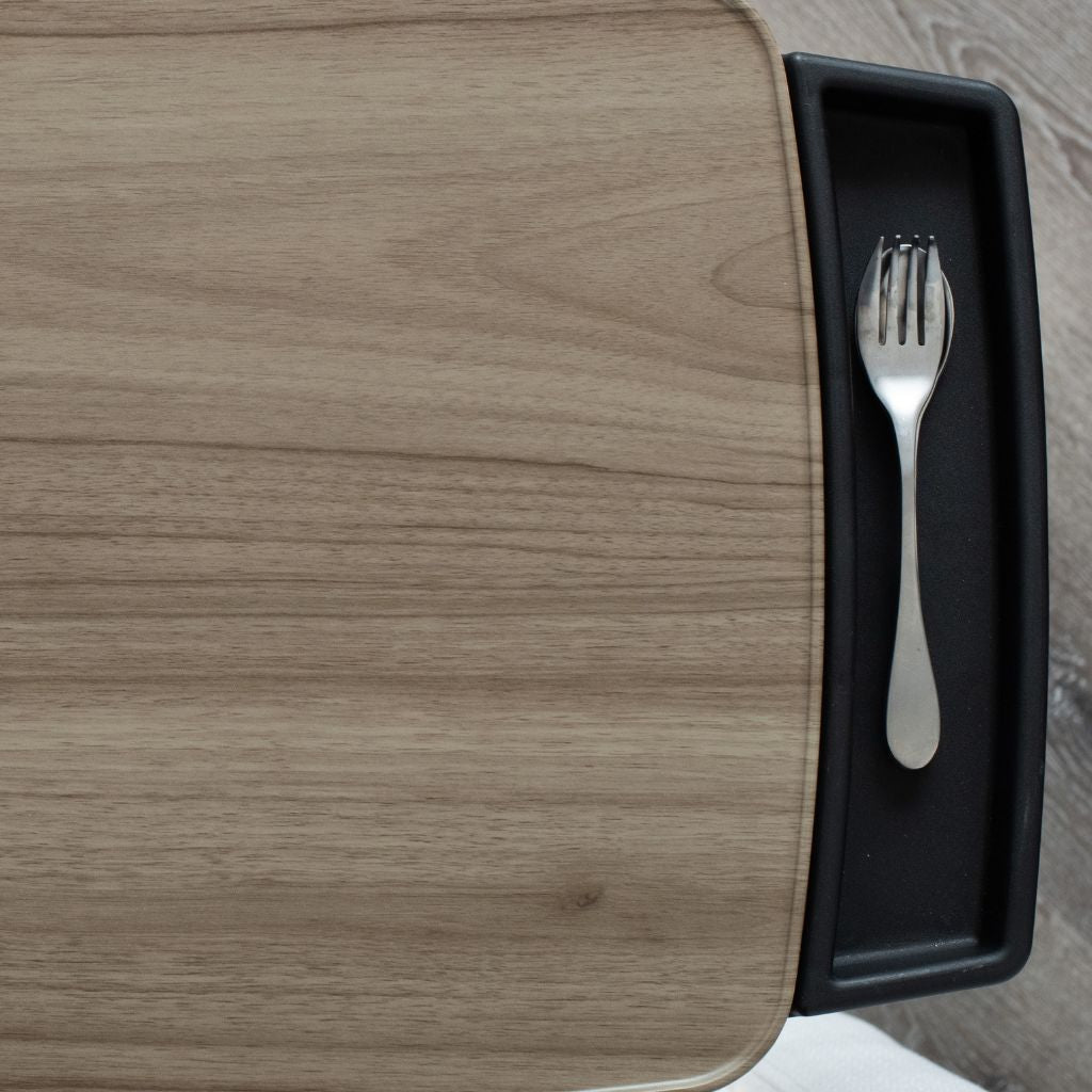 Fork in a black tray on a wooden surface