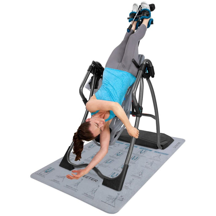 Image of woman using the Teeter inversion table on the Teeter inversion mat