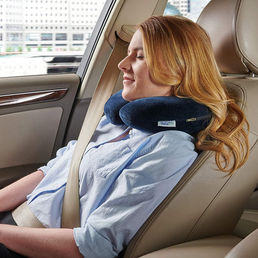 Tempur Pedic Travel Neck Pillow being worn by a woman that is sitting in a car
