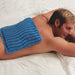 Man lying on stomach using the ProtoCold Reusable Cold Therapy Pads