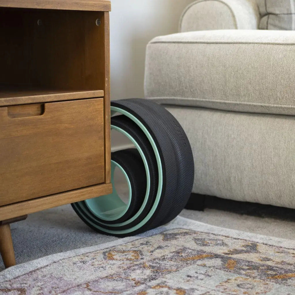 Chirp Wheel Plus shown by a gray couch and wooden side table